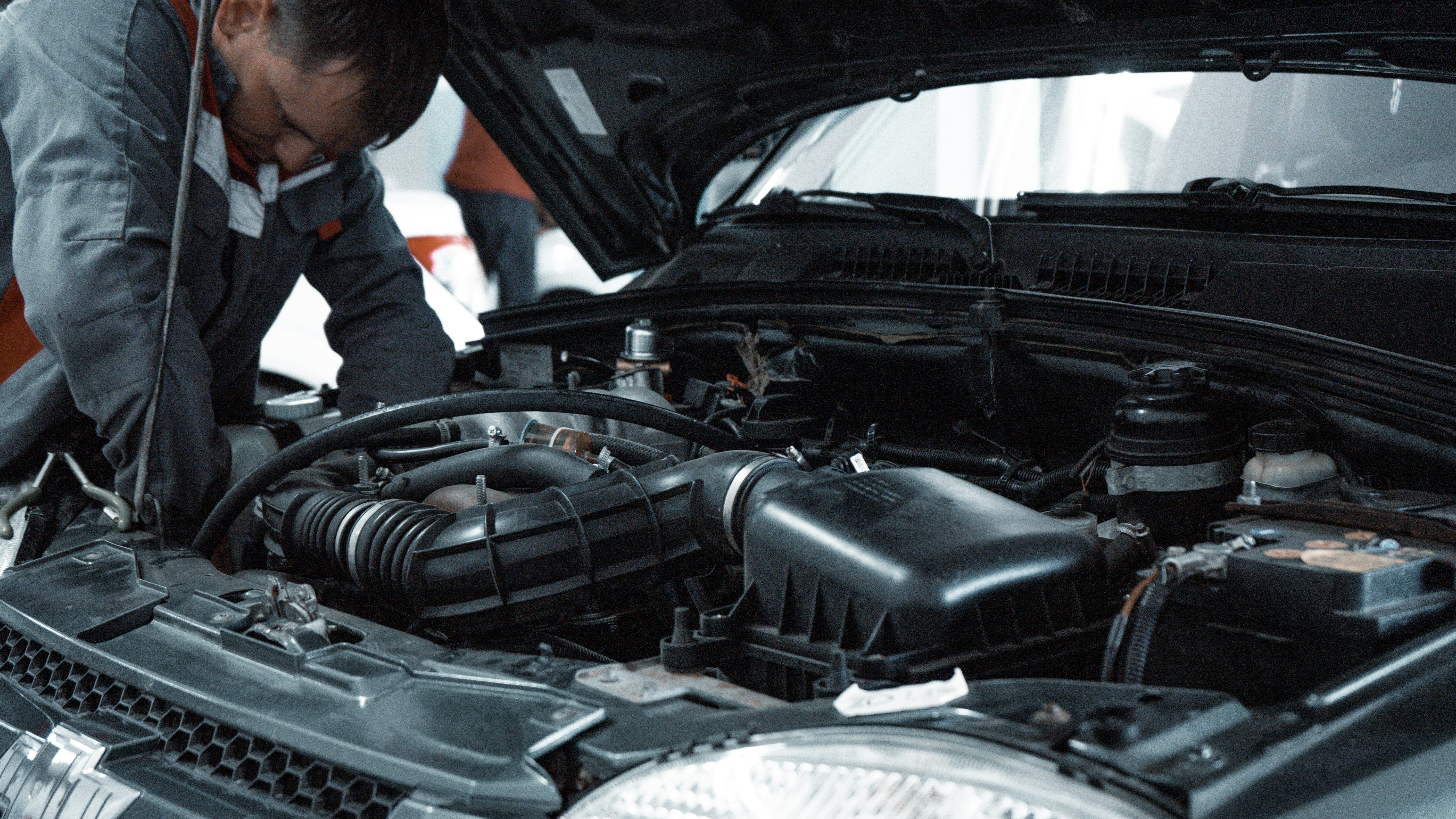 Monteur inspecteert de motor van een occasion